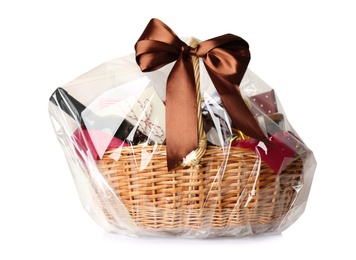 Photo of Wicker basket full of gifts isolated on white