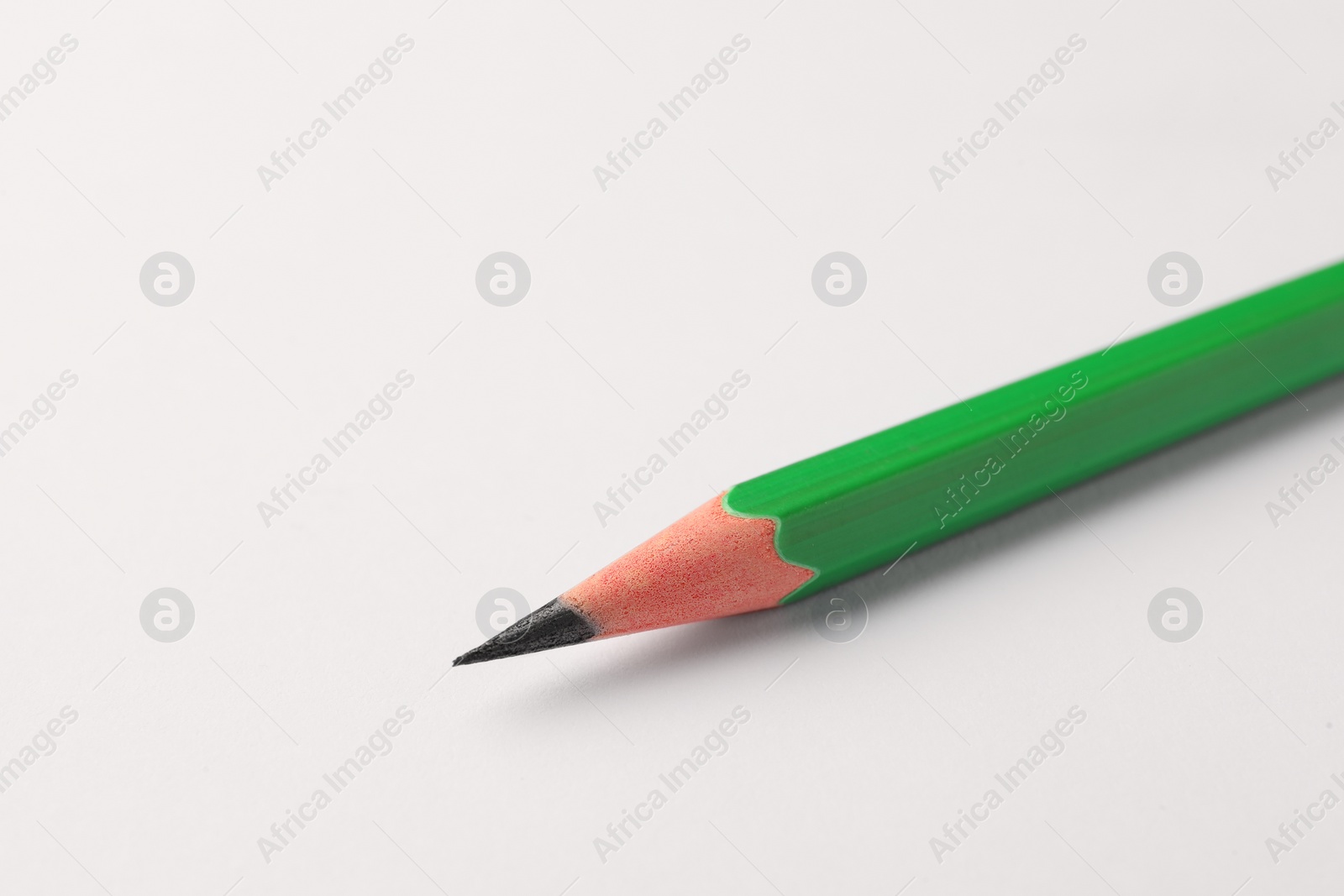 Photo of Sharp graphite pencil on white background, closeup. Space for text