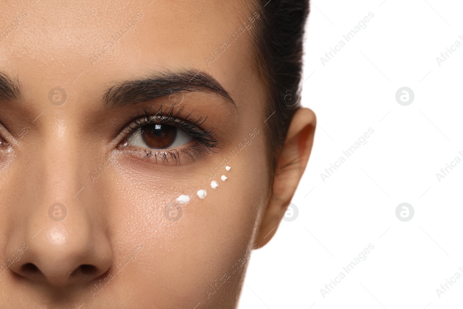 Photo of Woman with eye cream on white background, closeup. Skin care