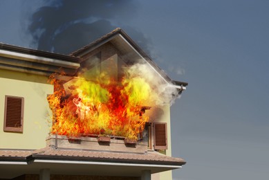 Image of Modern house engulfed in flames. Fire safety violations