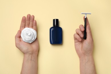 Photo of Man with shaving foam, razor and bottle on beige background, top view