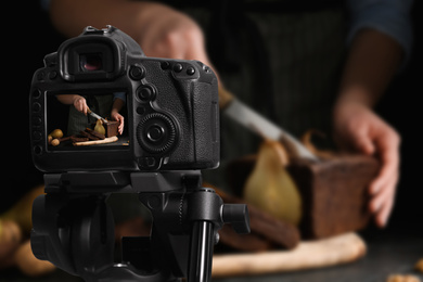 Image of Food photography. Shooting of woman cutting pear bread, focus on camera