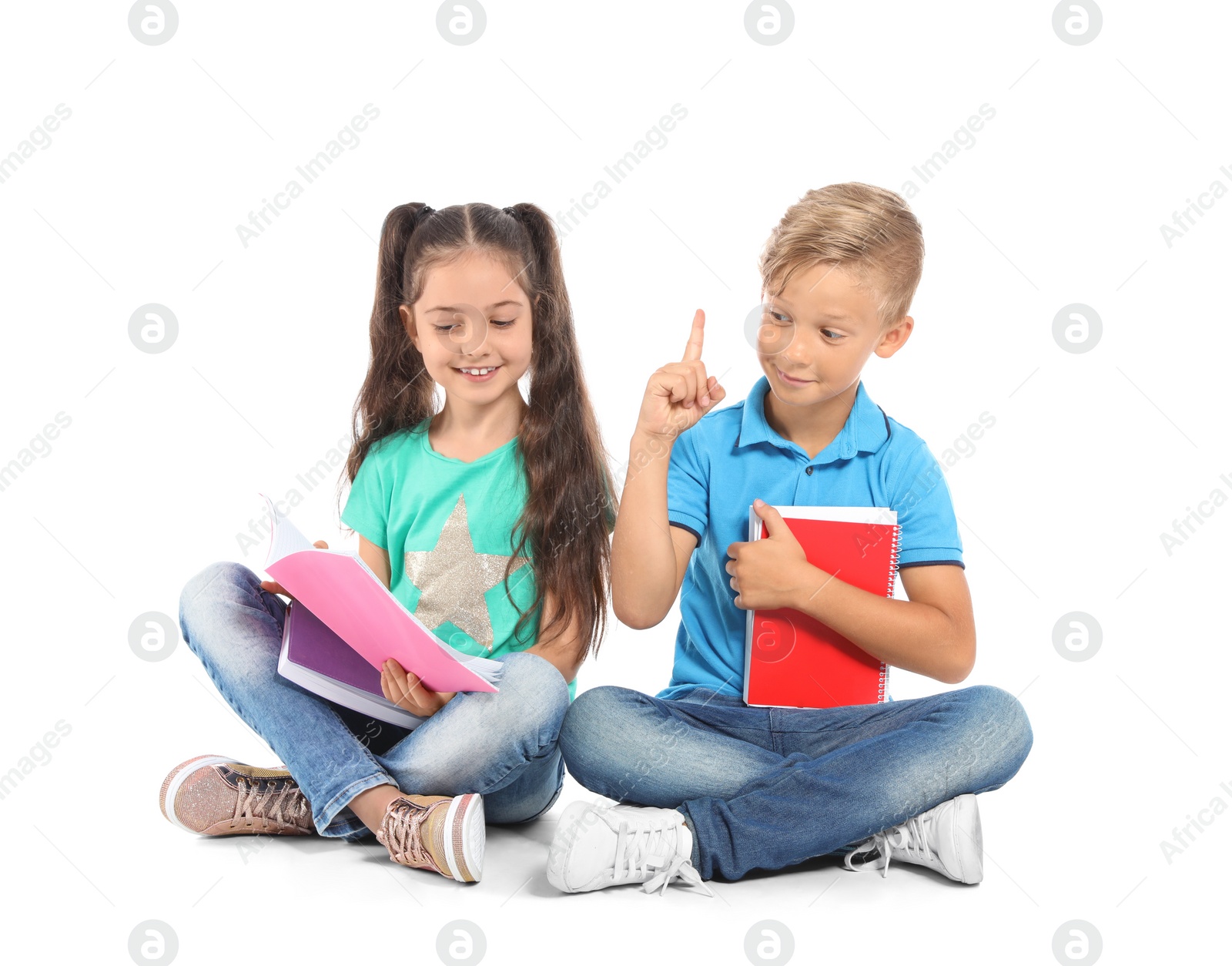 Photo of Little children with school supplies on white background