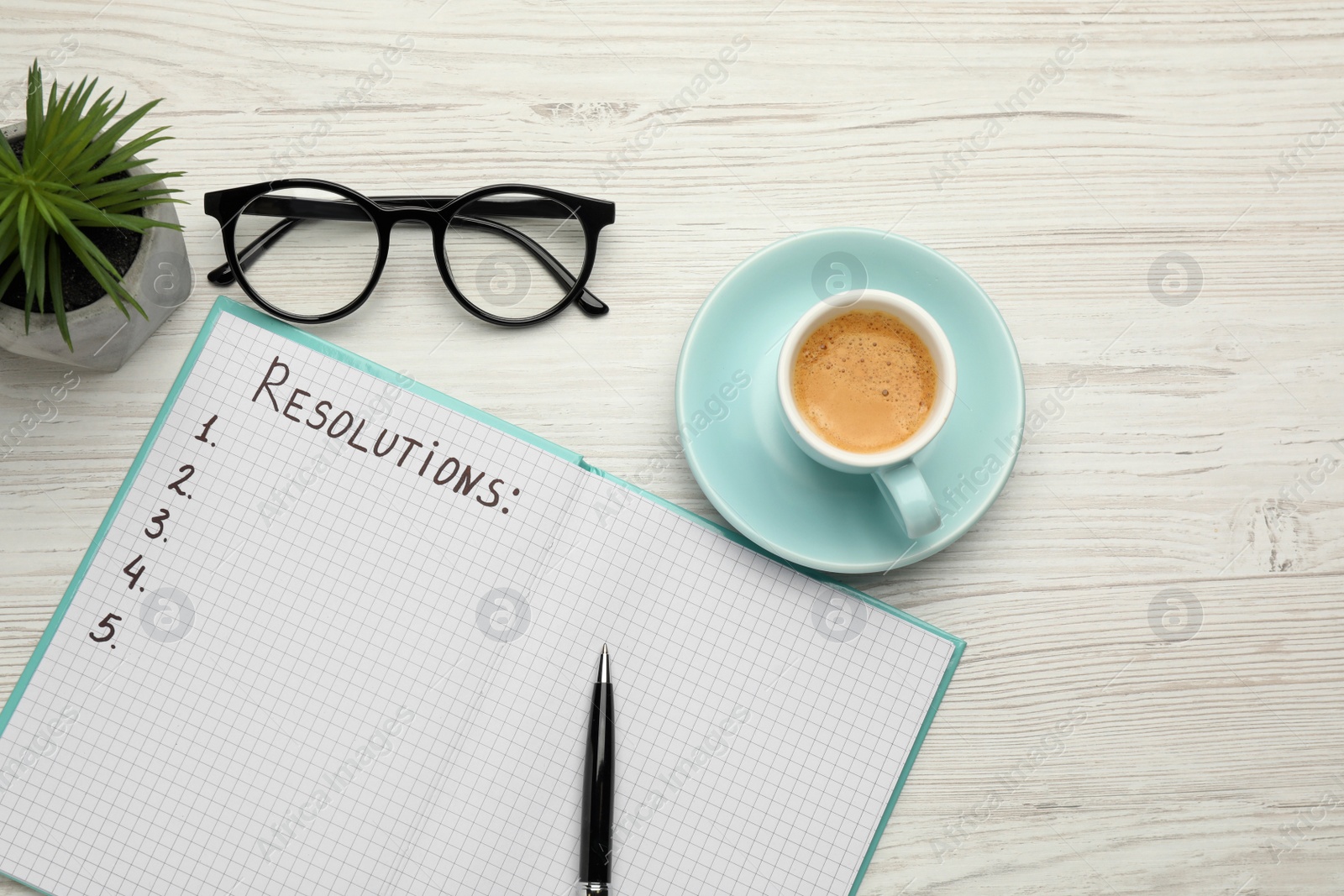 Photo of Making new year's resolutions. Flat lay composition with notebook on white wooden table