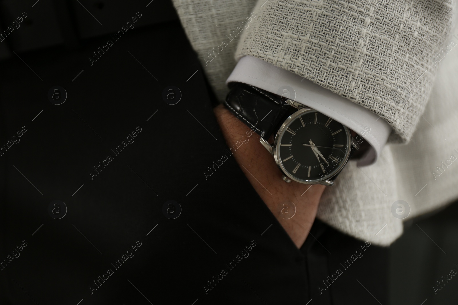 Photo of Businessman in suit with luxury wrist watch, closeup