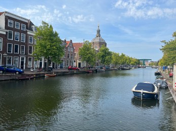 Leiden, Netherlands - August 28, 2022; Beautiful view of buildings near canal and boat on sunny day