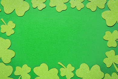 Photo of Frame of clover leaves on light green background, flat lay with space for text. St. Patrick's Day celebration