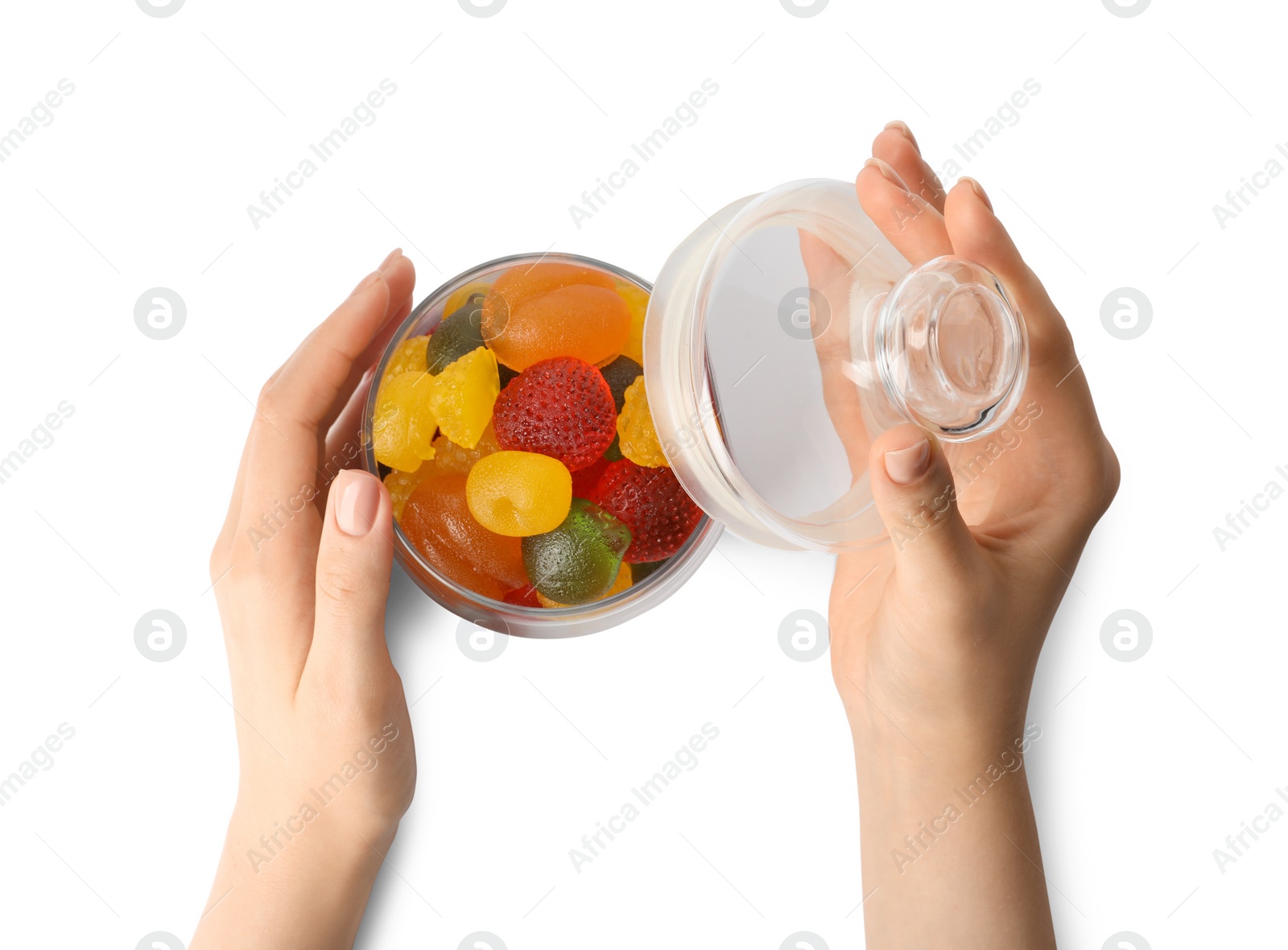 Photo of Woman with jar of delicious gummy candies on white background, top view