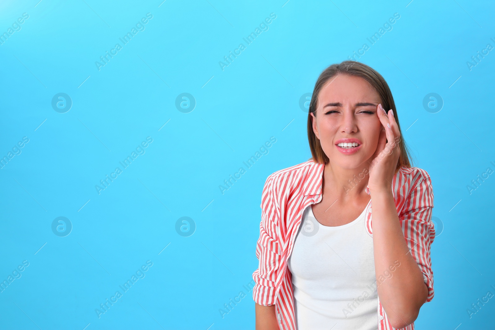 Photo of Young woman with vision problem on blue background. Space for text