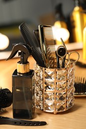 Photo of Set of hairdresser tools on table in salon