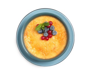 Delicious creme brulee with fresh berries isolated on white, top view