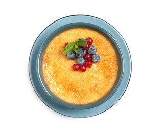 Photo of Delicious creme brulee with fresh berries isolated on white, top view