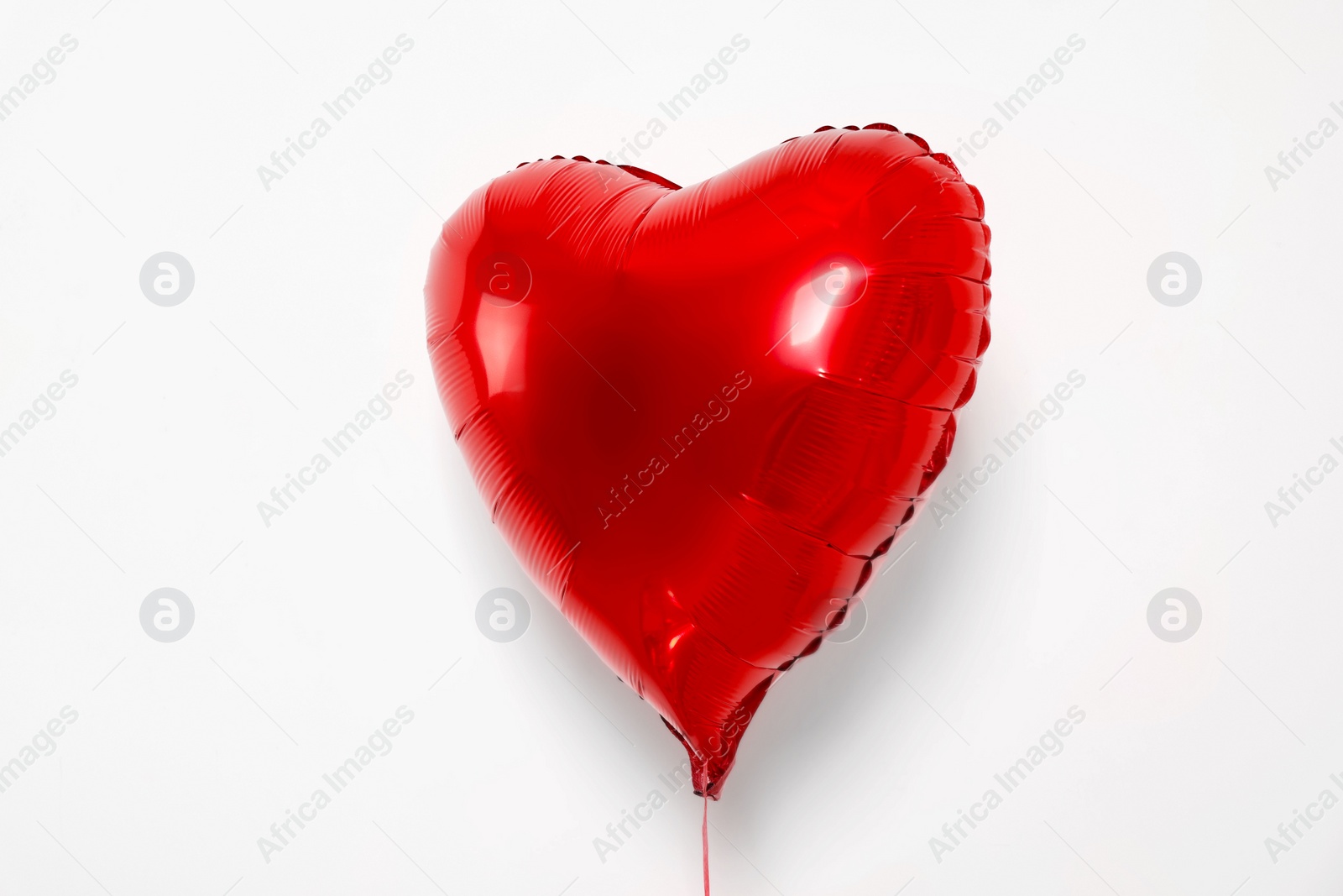 Photo of Red heart shaped balloon on white background