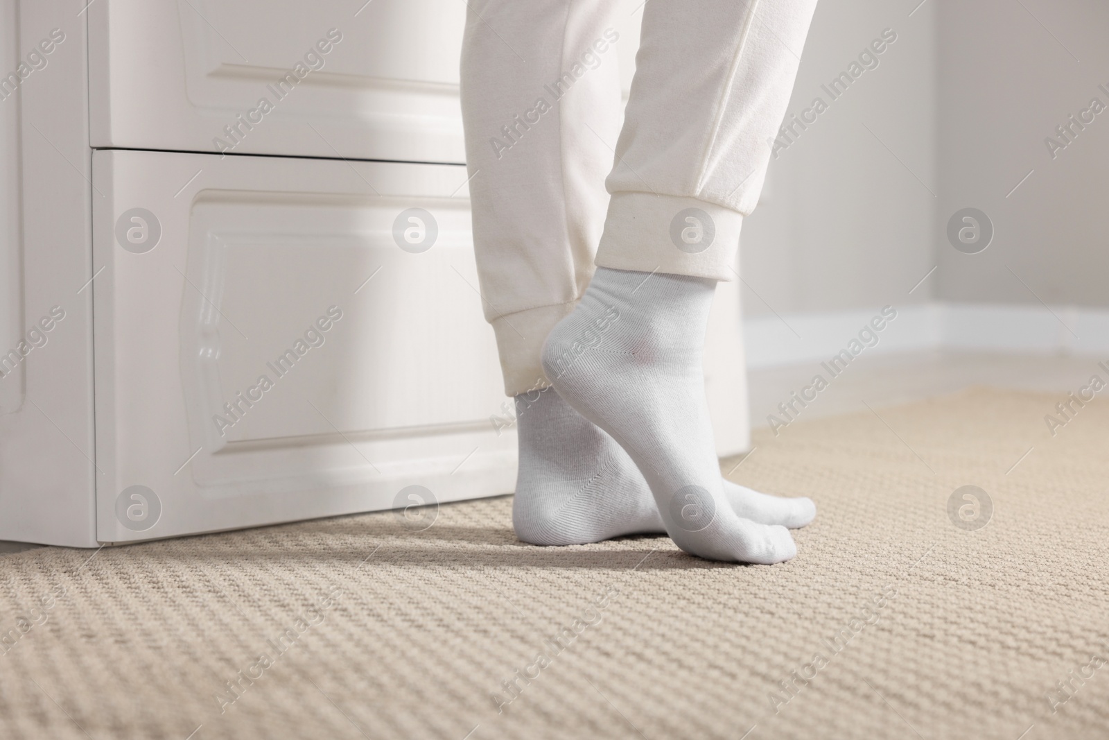 Photo of Woman in stylish white socks indoors, closeup