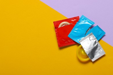 Photo of Condoms on color background, top view with space for text. Safe sex