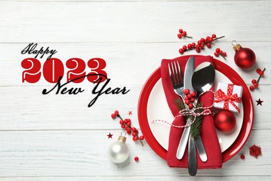Image of Happy New 2023 Year! Beautiful table setting and festive decor on white wooden background, flat lay 