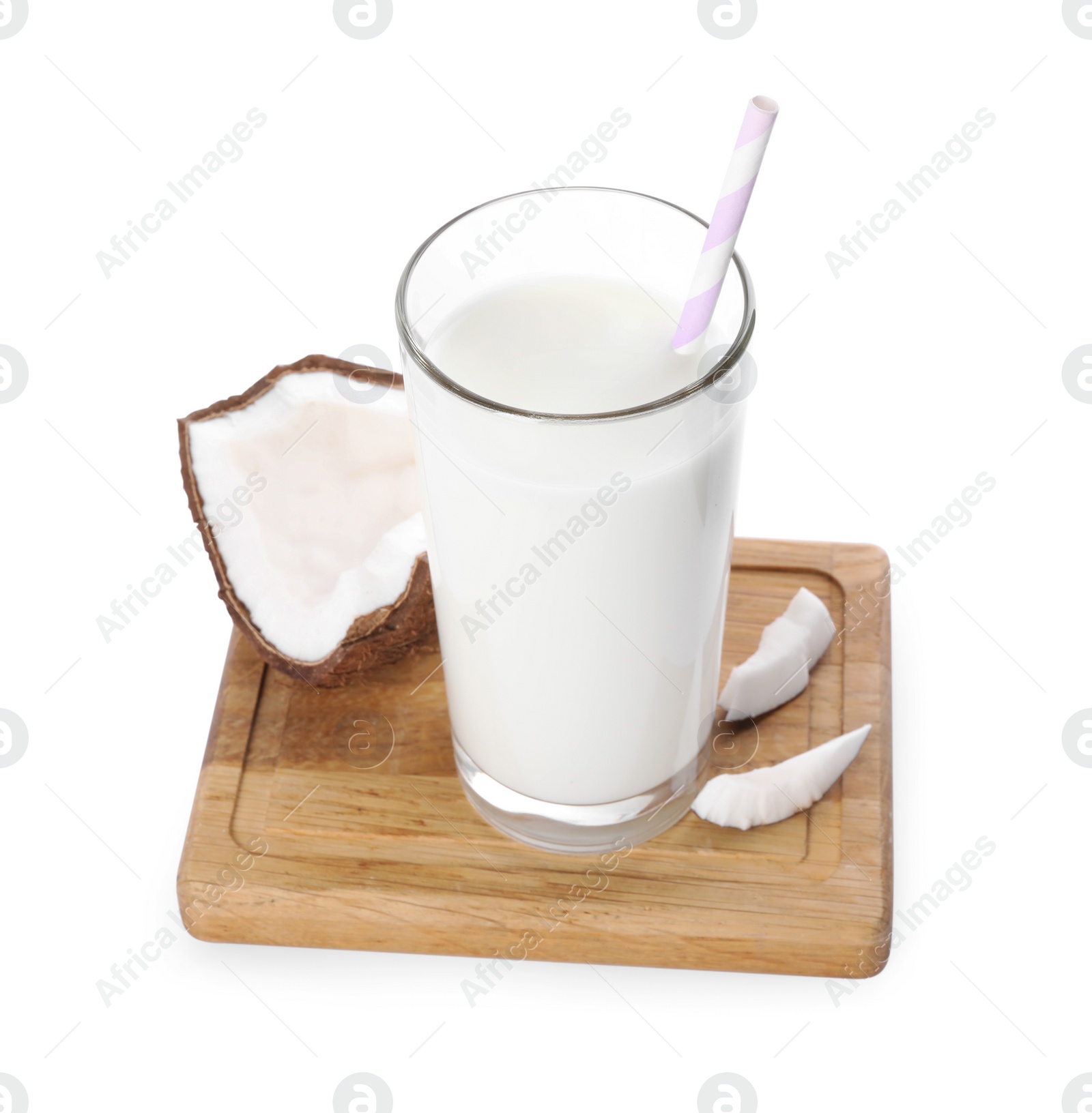 Photo of Glass of delicious vegan milk near coconut pieces on white background