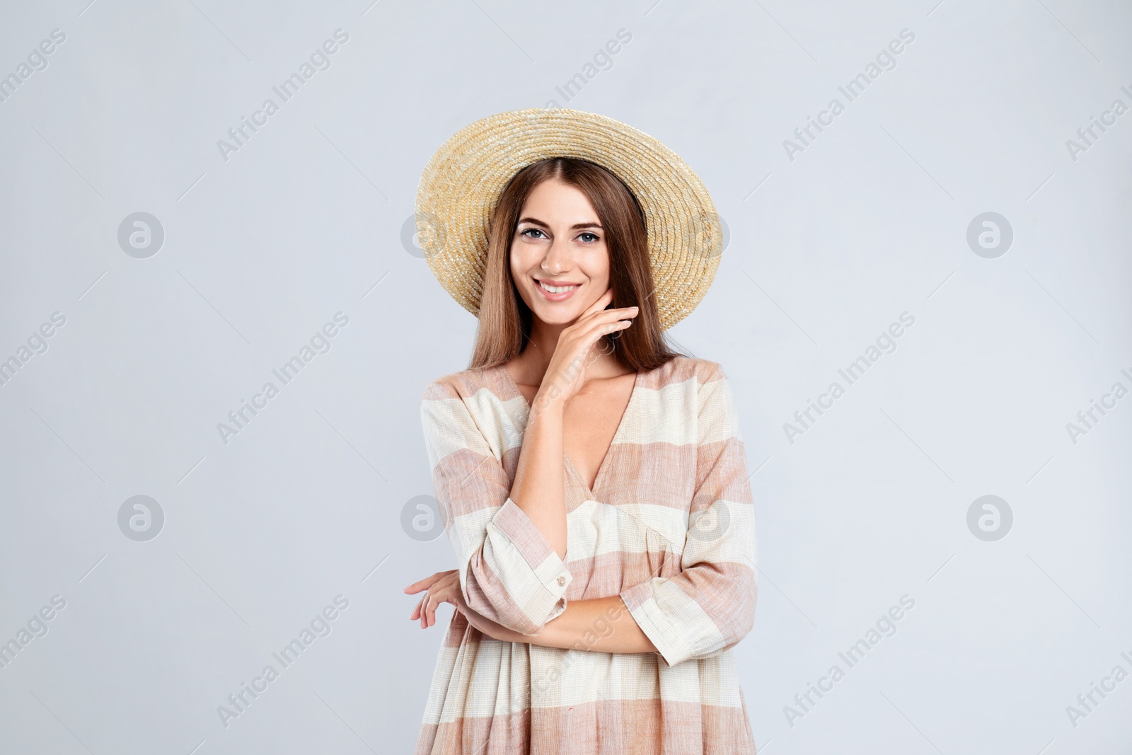 Photo of Young woman wearing stylish dress on light grey background