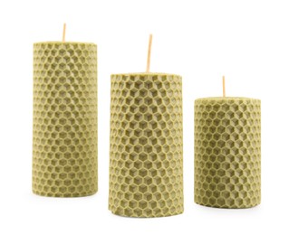 Photo of Stylish elegant beeswax candles on white background