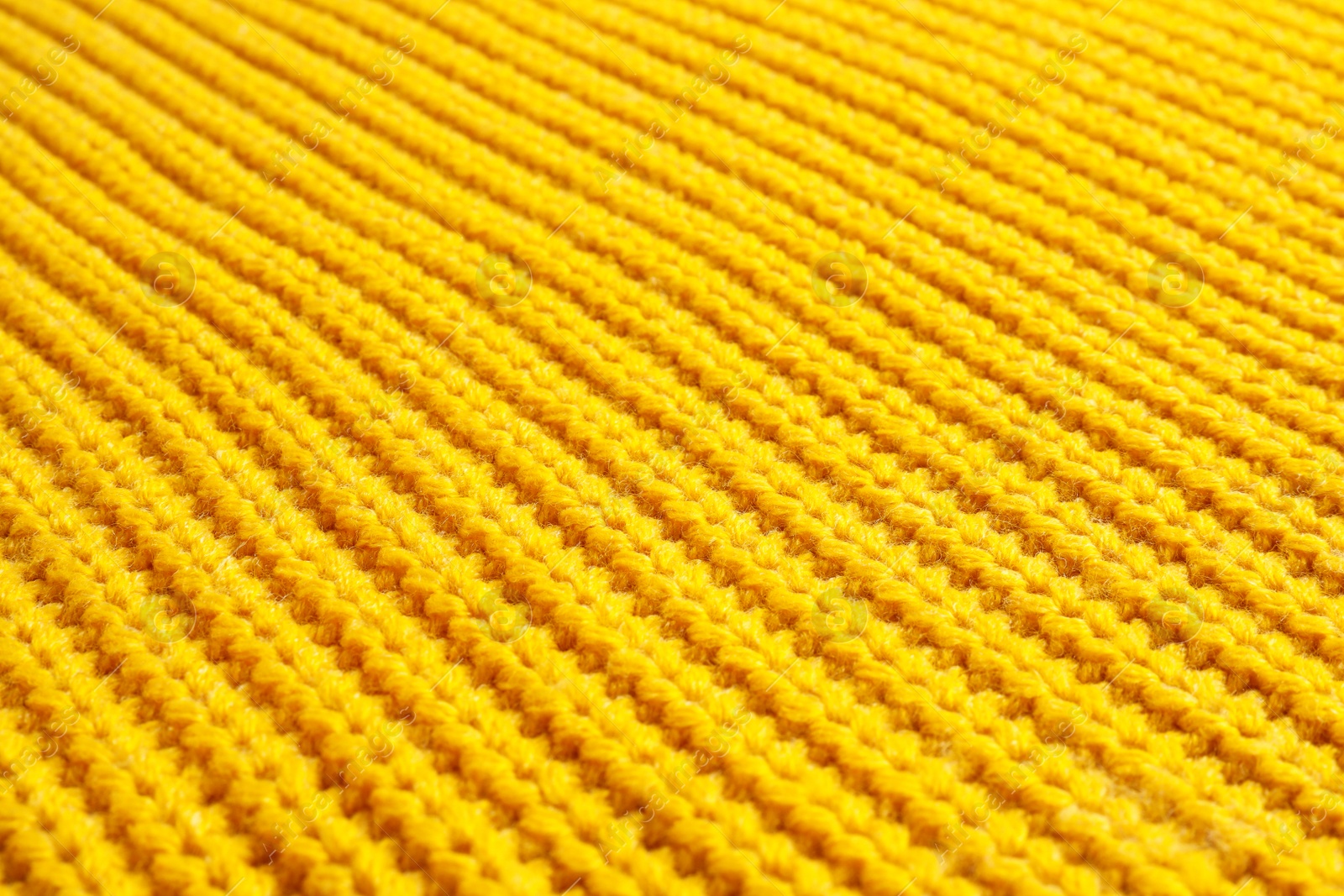 Photo of Yellow winter sweater as background, closeup view