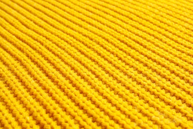 Photo of Yellow winter sweater as background, closeup view