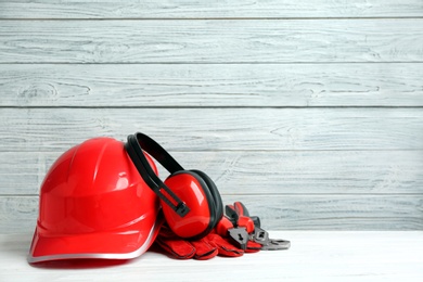 Photo of Composition with construction tools on table against wooden background, space for text