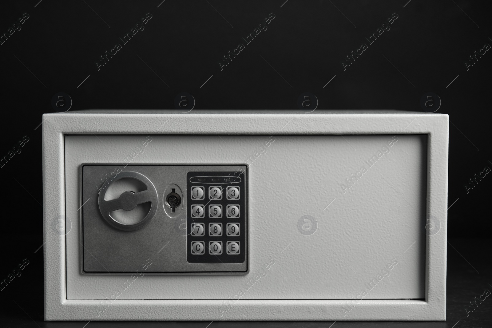 Photo of Steel safe with electronic lock on black background