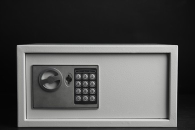 Steel safe with electronic lock on black background