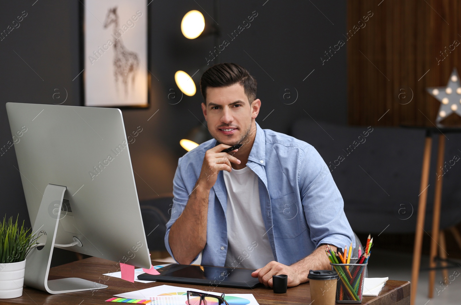 Photo of Male designer working at desk in office