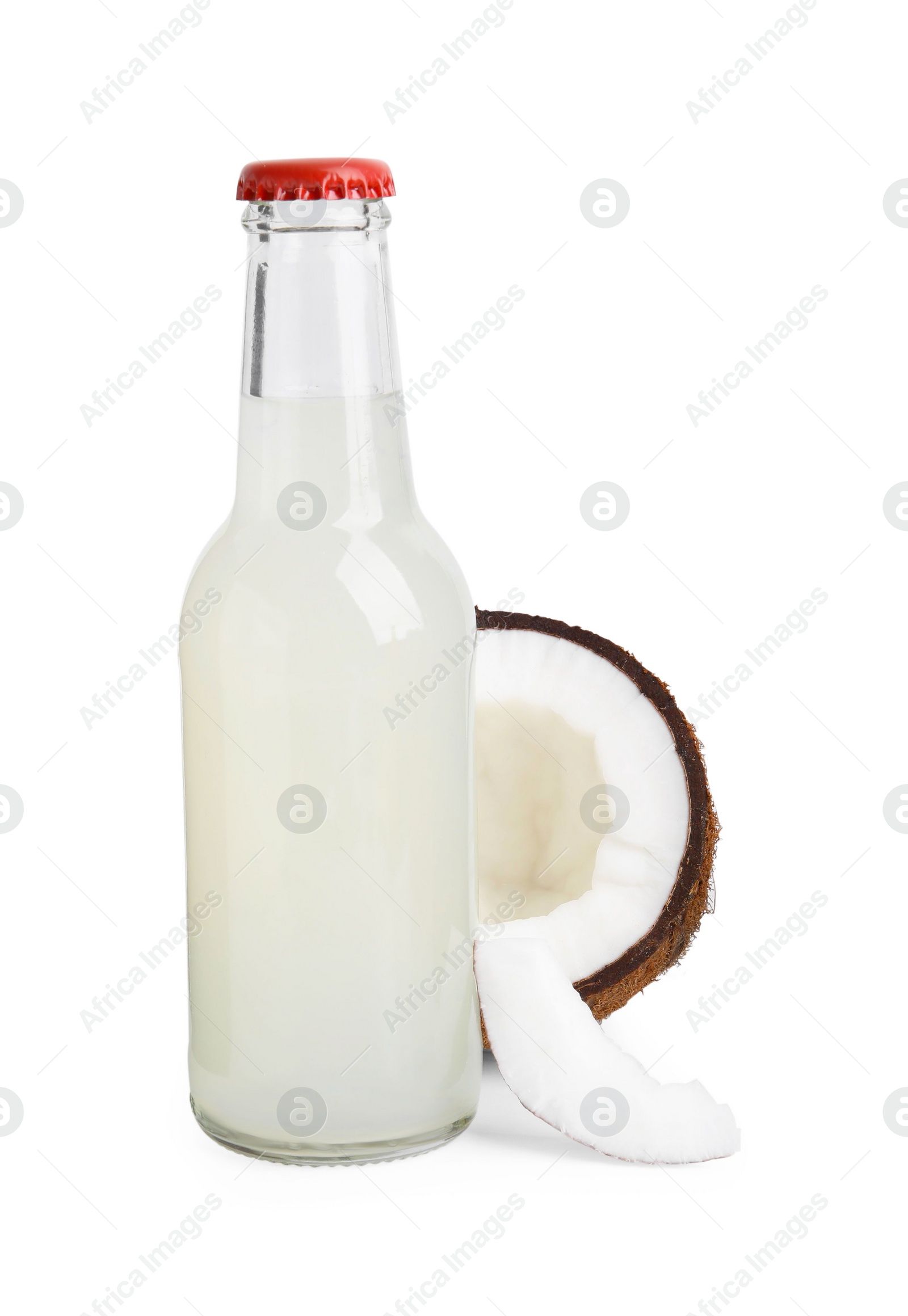 Photo of Delicious kombucha in glass bottle and coconut isolated on white