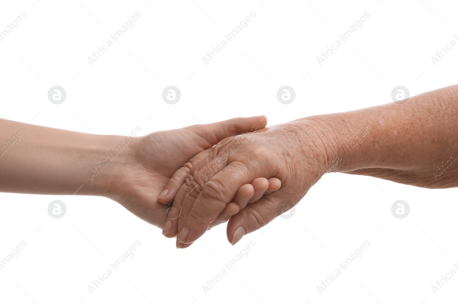 Photo of Young and elderly women holding hands together on white background, closeup