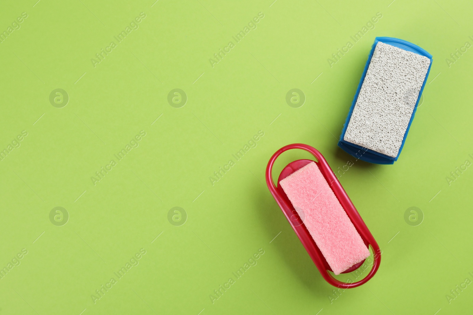 Photo of Pumice stones on green background, flat lay. Space for text