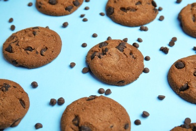 Photo of Delicious chocolate chip cookies on color background