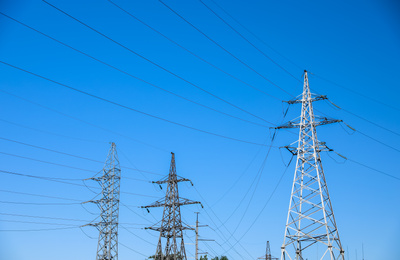 Modern high voltage towers against blue sky