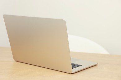 Modern laptop on wooden table. Space for text