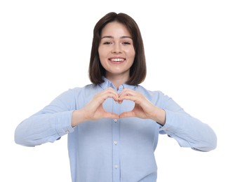Happy woman showing heart gesture with hands on white background