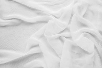 Beautiful white tulle fabric as background, top view