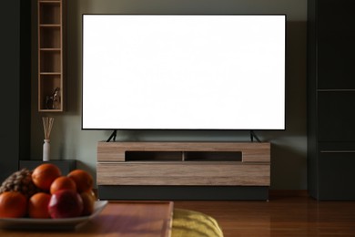 Modern TV set on table in room. Interior design