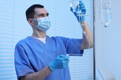 Photo of Nurse setting up IV drip in hospital