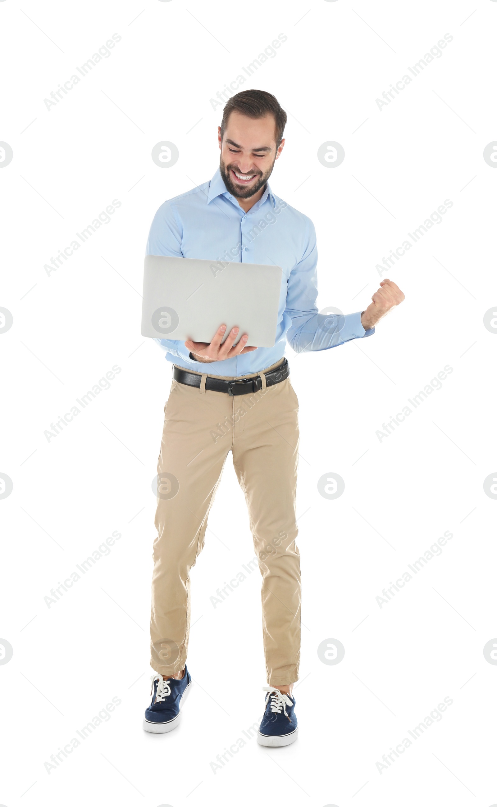 Photo of Emotional young man with laptop celebrating victory on white background