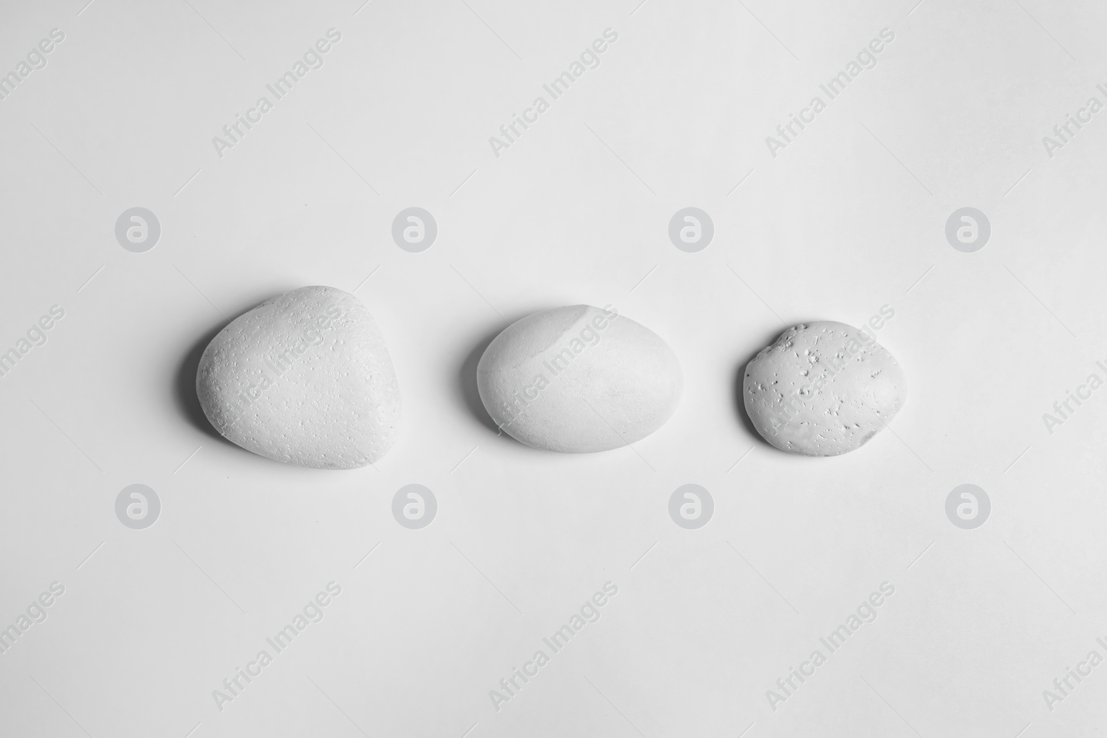 Photo of Zen stones on white background, top view