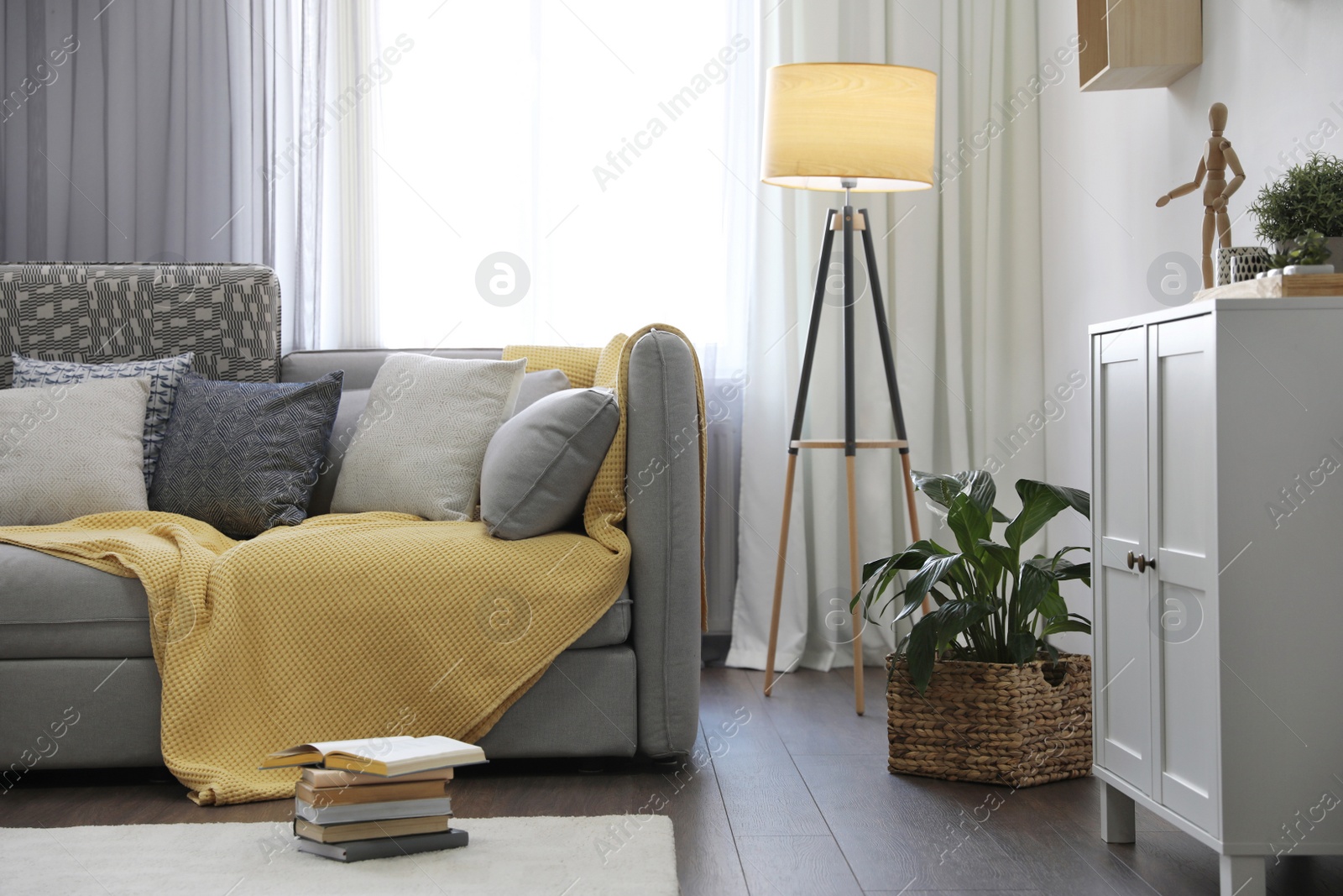 Photo of Elegant living room with comfortable sofa near window. Interior design