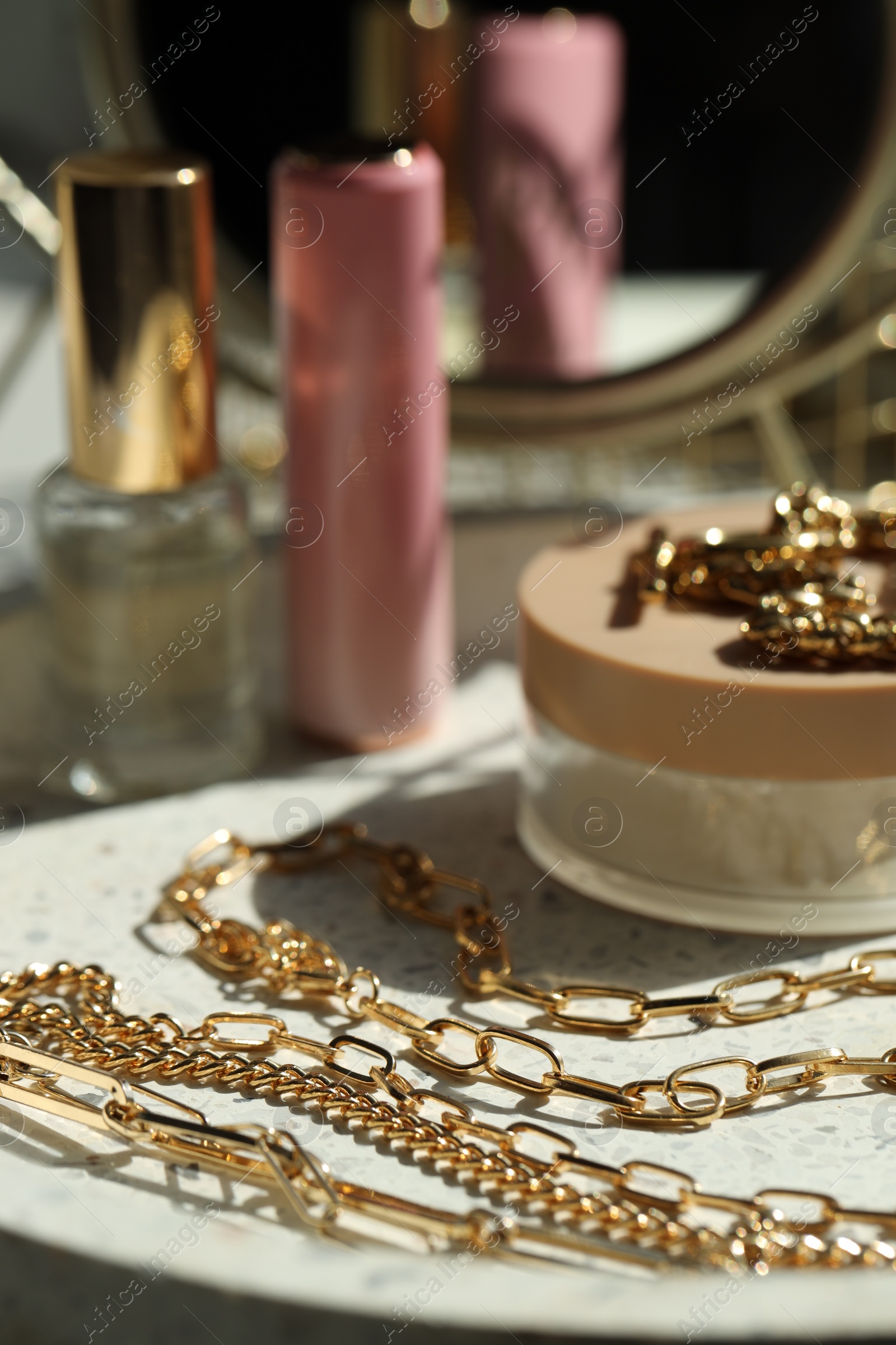 Photo of Metal chains and cosmetics on dish, closeup. Luxury jewelry