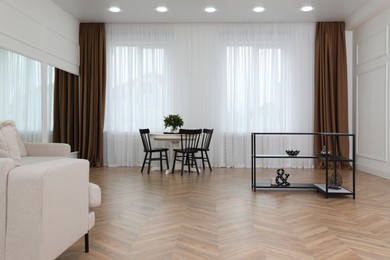 Modern room with parquet flooring and stylish furniture