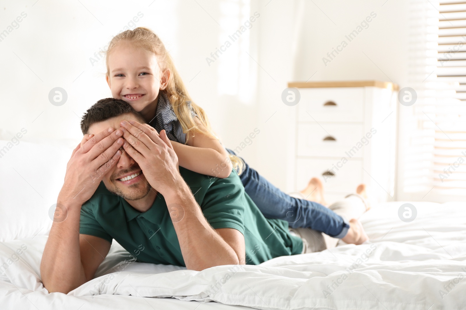 Photo of Dad and daughter spending time together at home. Happy Father's Day