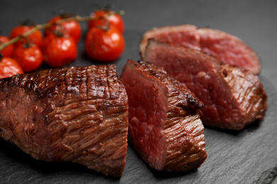 Photo of Delicious sliced beef tenderloin on table, closeup