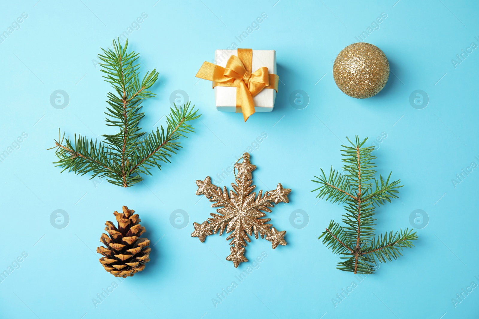 Photo of Flat lay Christmas composition with gift box and festive decor on color background