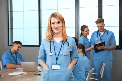 Medical student with groupmates in university library