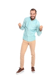 Young man celebrating victory on white background