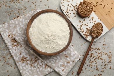 Flat lay composition with flour and wheat kernels on light grey table